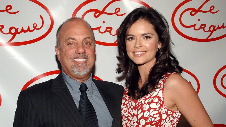 Billy Joel and Katie Lee posing for photos