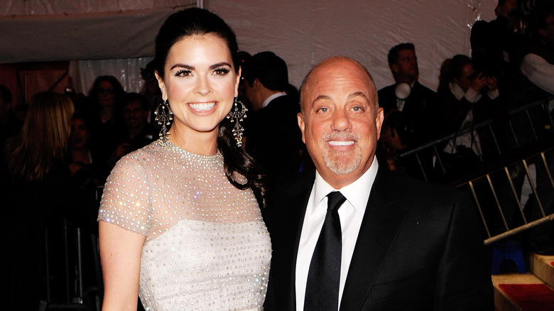 Billy Joel and Katie Lee posing for photos