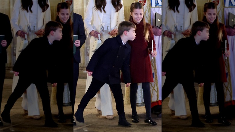 Prince Louis blowing out Princess Charlotte's candle