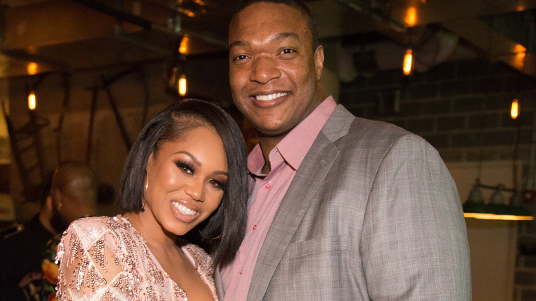 Monique Samuels smiling with husband former NFL player Chris Samuels