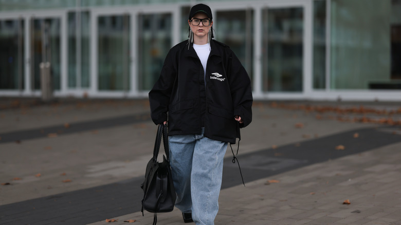 Person wearing baggy coat and jeans