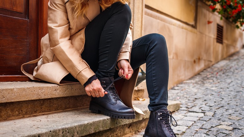 Person tying shoe lace