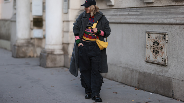 Woman posing on sidewalk