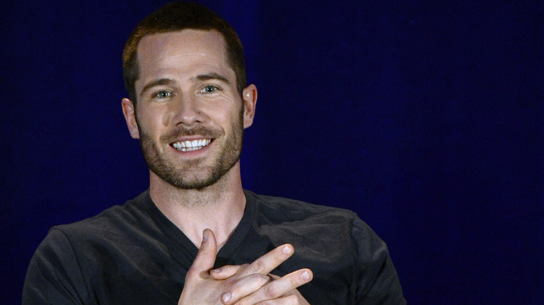 Luke Macfarlane smiling on panel