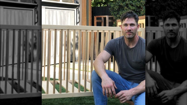 Luke Macfarlane posing in front of his custom-built crib
