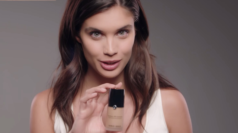 Woman holding Armani Beauty foundation