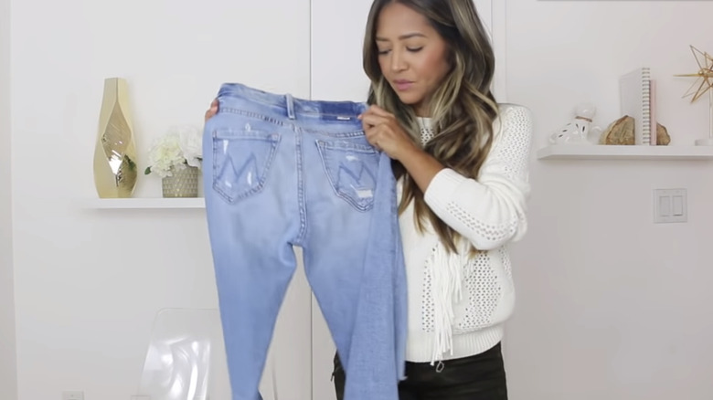 YouTuber holding Mother Denim