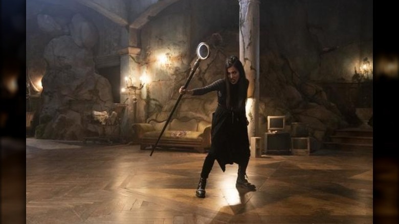 Lyrica Okano playing Nico Minoru holding her staff