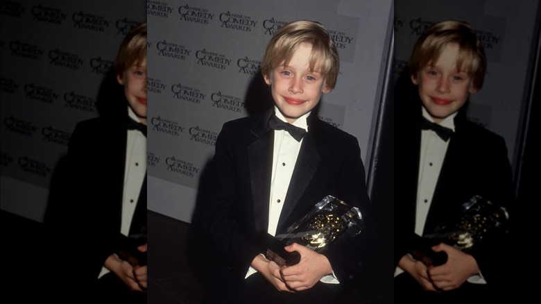Young Macaulay Culkin holding an award