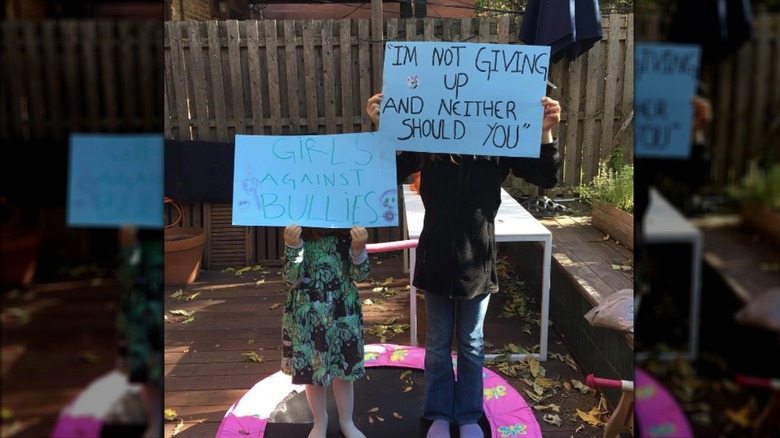 Maggie Gyllenhaal daughters holding posters