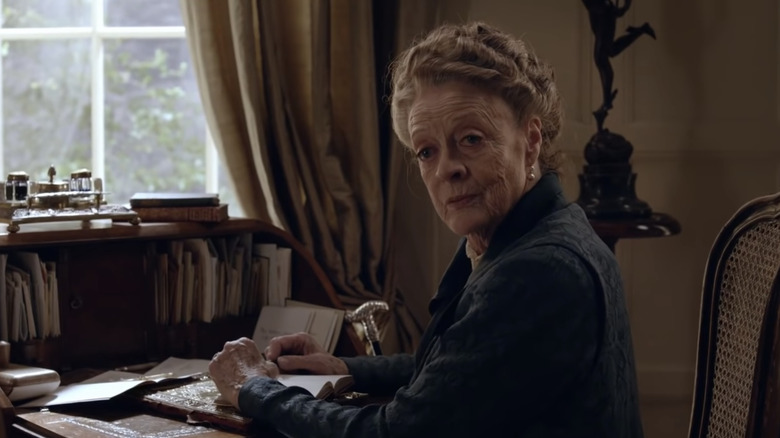 Lady Violet reading at desk