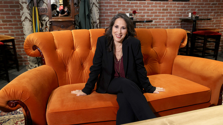 Maggie Wheeler smiling on Friends couch