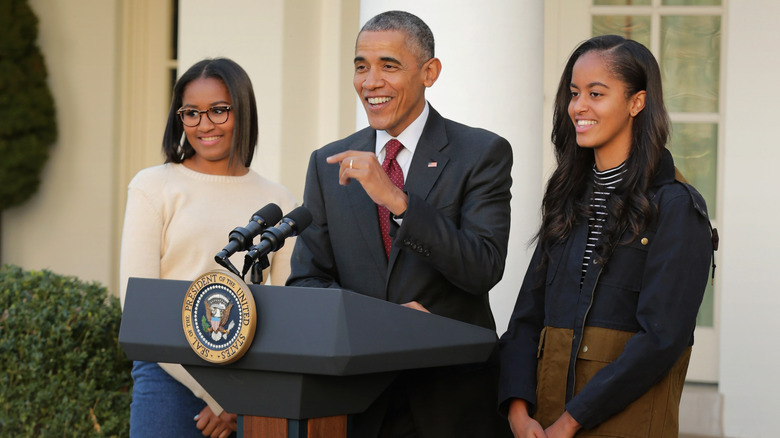 Sasha, Obama, and Malia Obama at podium