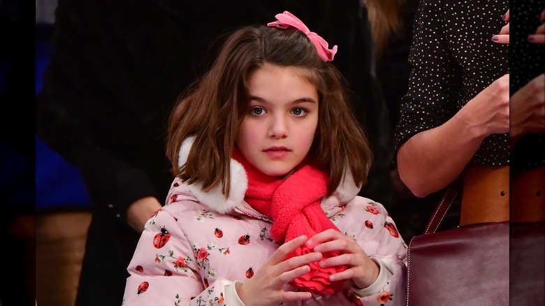 Suri Cruise wearing pink jacket