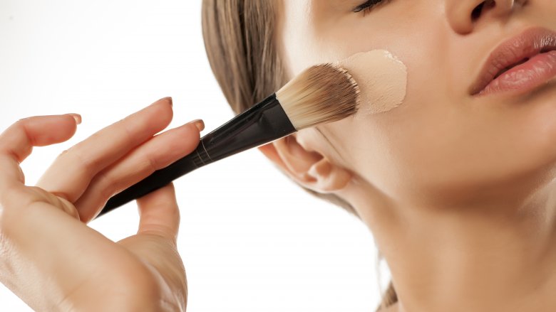 Woman applying foundation