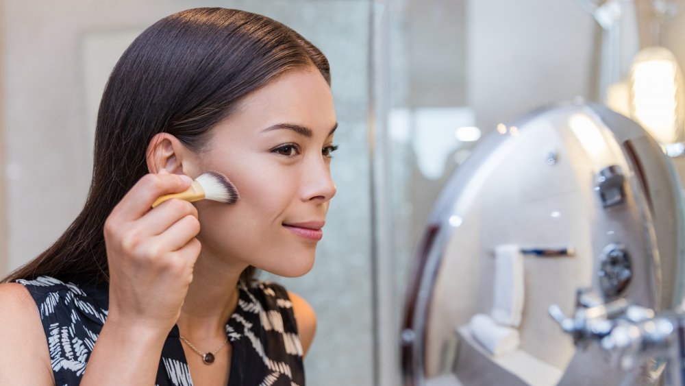 A woman blending her foundation