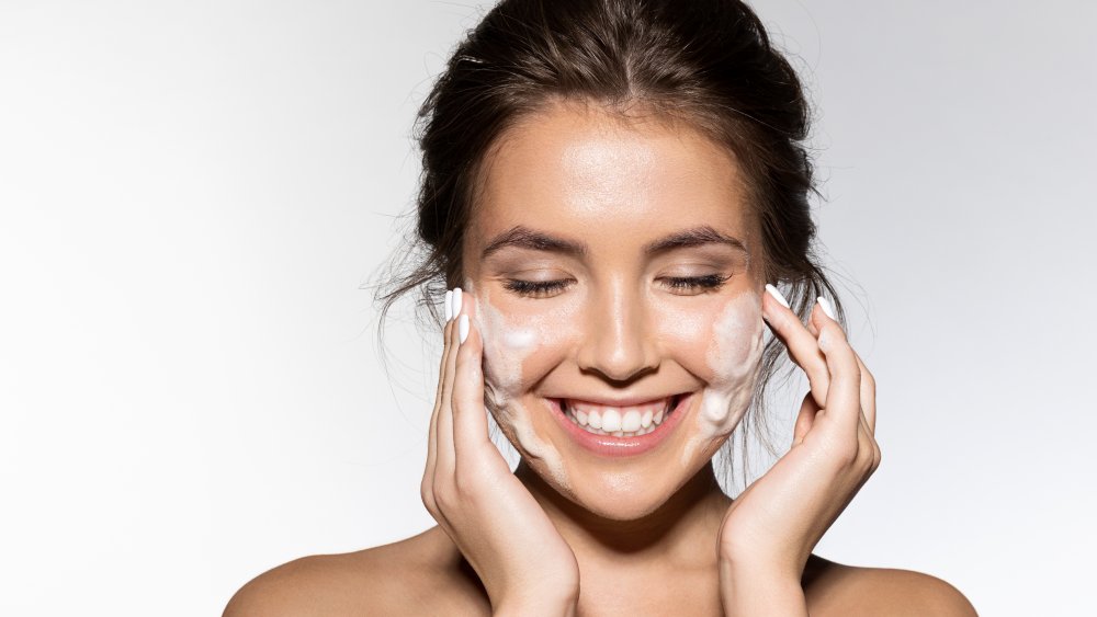 A woman washing her face