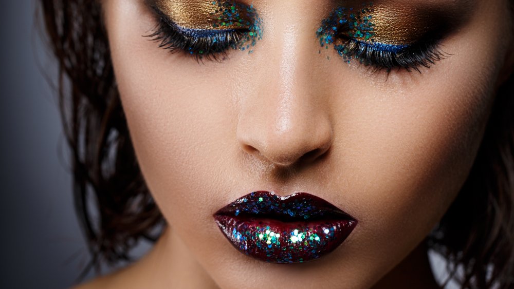 A woman wearing the glitter lips makeup trend