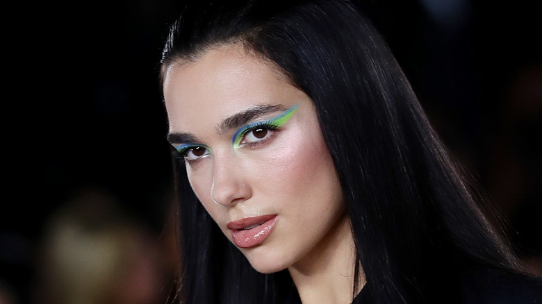 Dua Lipa wearing bright blue and green eyeliner