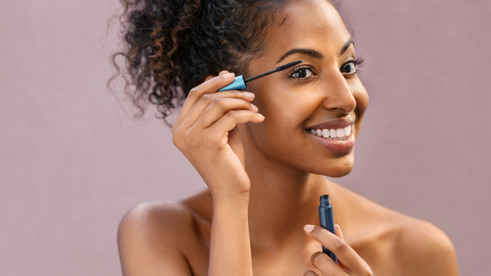 Woman applying eye make up