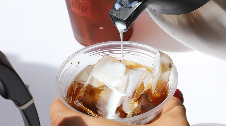 Cream pouring into coffee