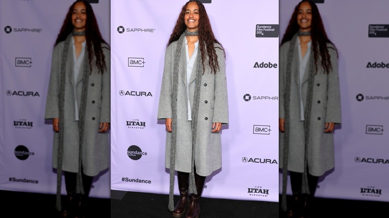 Malia Obama posing in grey coat on red carpet