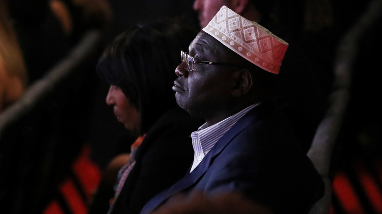 profile of Malik Obama looking serious