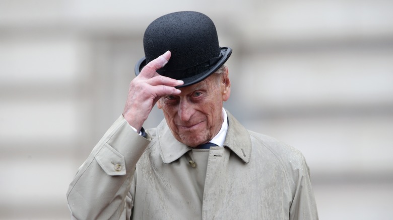 Prince Philip adjusting his hat