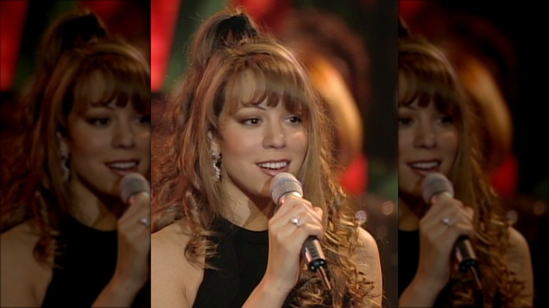 A young Mariah Carey with a microphone