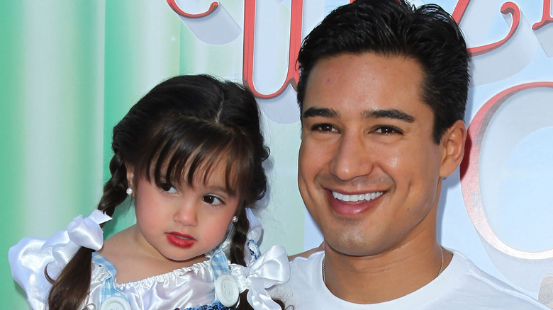 Mario Lopez with Gia, smiling 