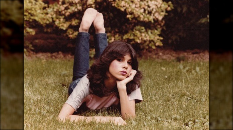 14-year-old Marisa Tomei laying on the grass