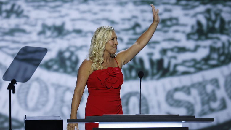 Marjorie Taylor Greene waving as she walks onto the stage at the RNC