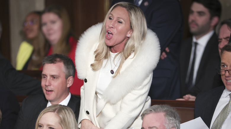 Marjorie Taylor Greene in mid-shout with fuzzy coat