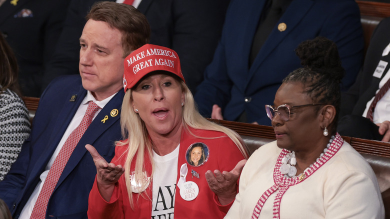 Majorie Taylor Green in MAGA hat and mouth open