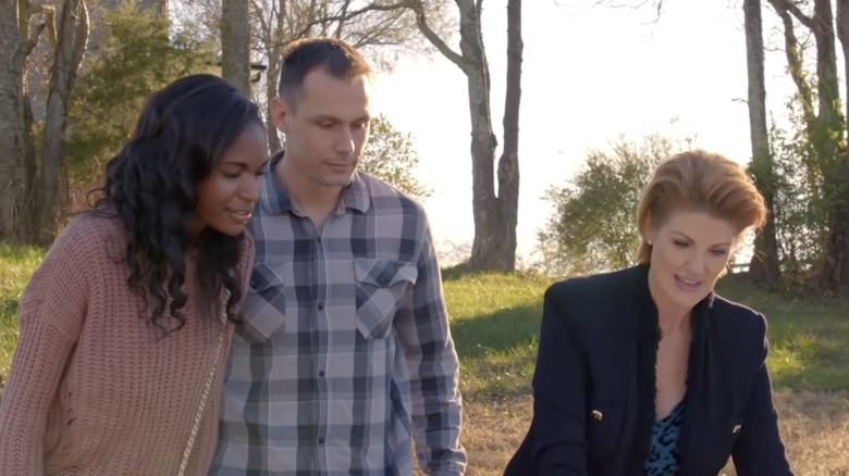 A couple looking at blue prints of a home with Nichole Holmes