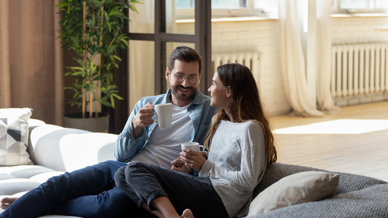 couple with mugs talking