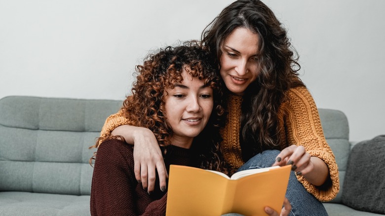 lesbian couple reading a book