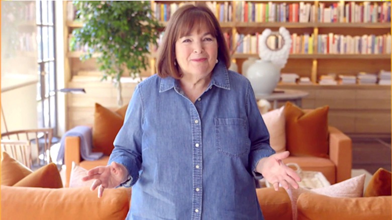 Ina Garten in denim shirt standing in library