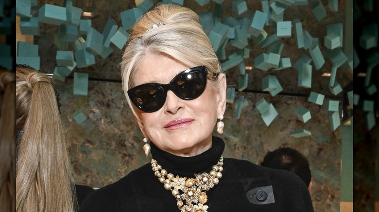 Martha Stewart in sunglasses, slight smile, hair in beehive, chunky necklace.