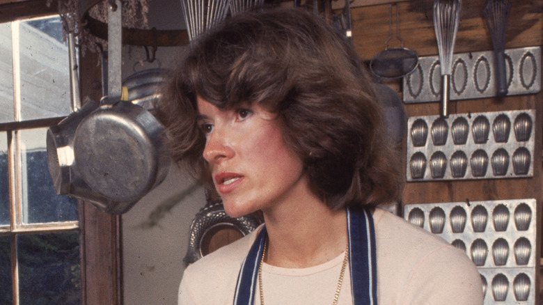 Martha Stewart in a kitchen, brunette hair, looking off camera.