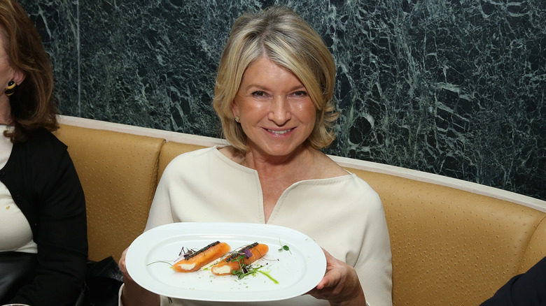 Martha Stewart holds a fancy plate of food 