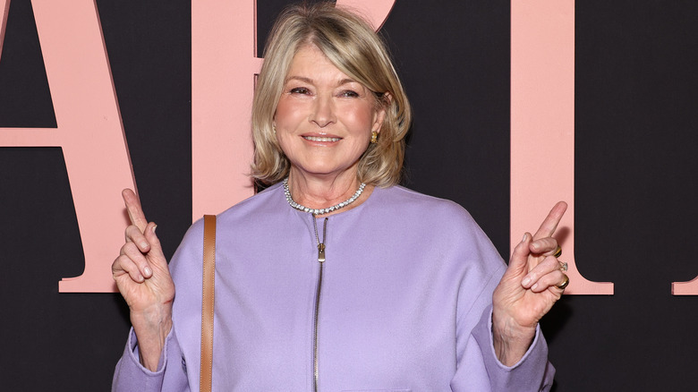 Martha Stewart smiling and pointing her fingers