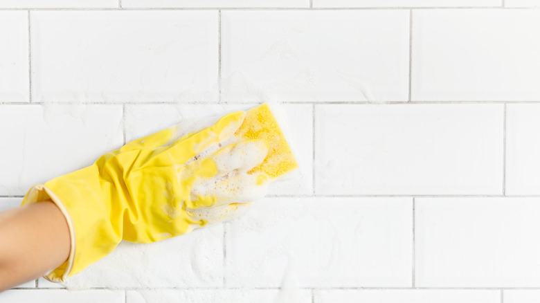 White tile being washed with sponge