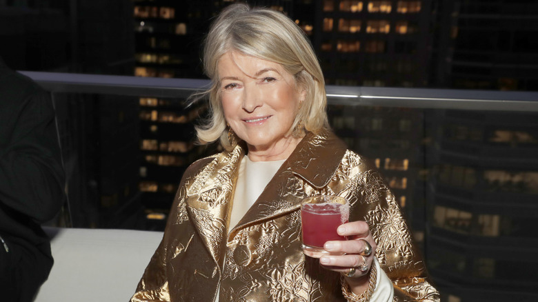 Martha Stewart smiling and raising a glass to toast