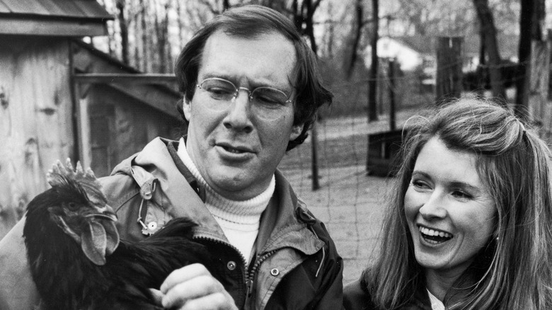 Andy Stewart holding a chicken and Martha Stewart laughing