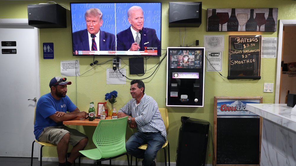 Men at a bar watching debates 