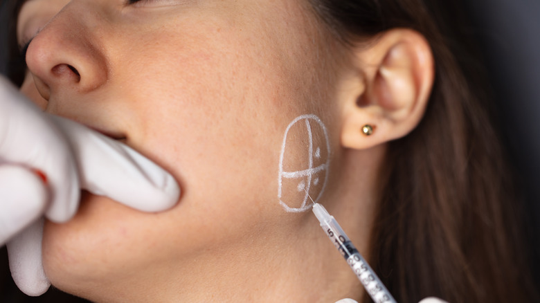 woman getting injection in jaw