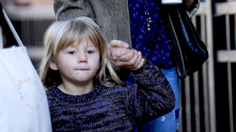 Young Matilda Ledger holding her mom's hand