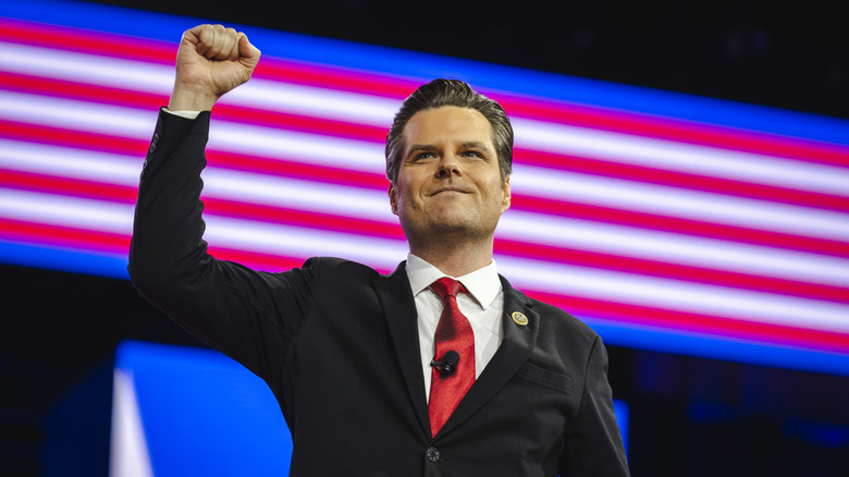 Matt Gaetz throws his hand up in the air