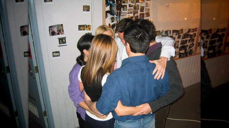 Friends cast sharing a group hug